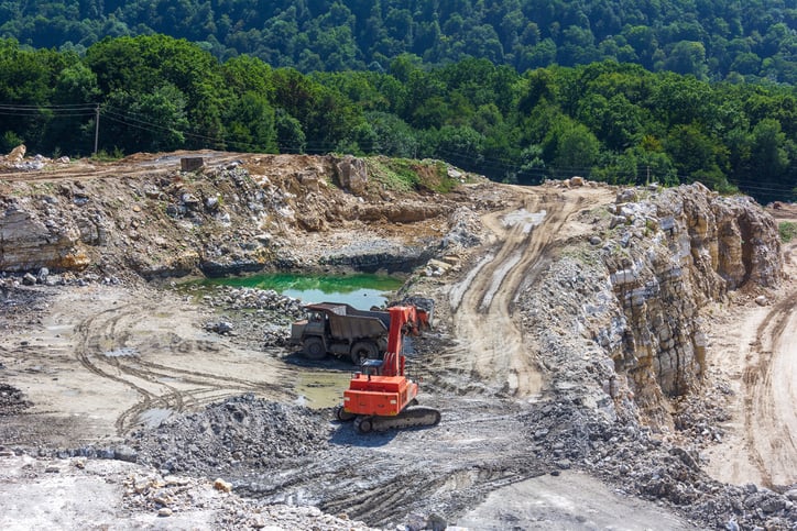 An excavator mining in a gypsum mine.